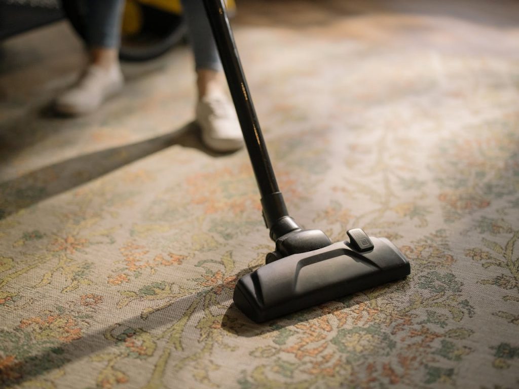 Crafting Captivating Headlines: Your awesome post title goes here Close-up of a vacuum cleaner on a patterned carpet in a sunlit room, capturing a moment of household cleaning.